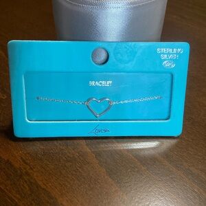 NWT sterling silver bracelet with heart pendant in center, measures 7 inches.